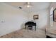 Bright piano room with a black grand piano and a window that brings in natural light at 5413 Wishing Arch Dr, Apollo Beach, FL 33572