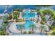 Aerial view of an outdoor community pool area with palms, lounge chairs, slide, and marina at 5413 Wishing Arch Dr, Apollo Beach, FL 33572