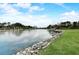 Scenic waterfront view with a dock and a lush green lawn at 5413 Wishing Arch Dr, Apollo Beach, FL 33572