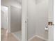 Bathroom featuring a walk-in shower, neutral tile, and linen closet at 5613 Kingsley Corner Way, Lithia, FL 33547