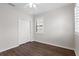 Bright bedroom with dark hardwood floors, white trim, ceiling fan and window shutters at 5613 Kingsley Corner Way, Lithia, FL 33547