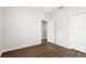 Well-lit bedroom with wood-look flooring, white walls and trim, and neutral decor at 5613 Kingsley Corner Way, Lithia, FL 33547