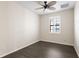 Well-lit bedroom featuring wood-look flooring, a ceiling fan, and a window with shutters at 5613 Kingsley Corner Way, Lithia, FL 33547