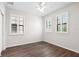 Inviting bedroom featuring wood-look floors, plantation shutters, and ample natural light at 5613 Kingsley Corner Way, Lithia, FL 33547