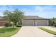 Beautiful townhome featuring attached garages, spacious driveway, and well-kept landscaping at 5613 Kingsley Corner Way, Lithia, FL 33547