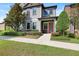 Inviting home exterior with a red front door and lush, green landscaping at 5613 Kingsley Corner Way, Lithia, FL 33547