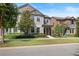 Beautiful two-story home with classic design, manicured lawn, and colorful landscaping at 5613 Kingsley Corner Way, Lithia, FL 33547