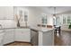 Kitchen island with granite counters, stainless steel dishwasher and tiled backsplash at 5613 Kingsley Corner Way, Lithia, FL 33547