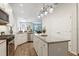 Kitchen with granite counters, stainless appliances, white cabinets and open concept living at 5613 Kingsley Corner Way, Lithia, FL 33547