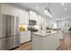 Spacious kitchen featuring modern appliances, granite countertops, and white cabinetry at 5613 Kingsley Corner Way, Lithia, FL 33547