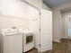 Bright laundry room features side by side washer and dryer with shelving and hanging rack at 5613 Kingsley Corner Way, Lithia, FL 33547