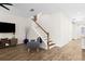 Open living room features wood-look tile floors and stairs to the second level at 5613 Kingsley Corner Way, Lithia, FL 33547