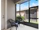 Relaxing screened-in patio with wicker chairs and a view of the yard at 5613 Kingsley Corner Way, Lithia, FL 33547