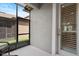 Relaxing screened-in patio with wicker chairs and a view of the yard at 5613 Kingsley Corner Way, Lithia, FL 33547