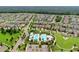 Aerial view showcasing a community with lush landscaping, swimming pool, and neighborhood streets at 5717 Village Center Dr, Lithia, FL 33547