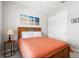 Bedroom featuring a wooden bed frame, beach themed artwork, side table, and closet at 5717 Village Center Dr, Lithia, FL 33547