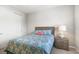 Cozy bedroom featuring a patterned duvet, nightstand with lamp, and closet at 5717 Village Center Dr, Lithia, FL 33547