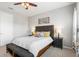 Bedroom with a dark padded headboard, ceiling fan, and coordinating nightstands with lamps at 5717 Village Center Dr, Lithia, FL 33547