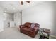 Bonus room with carpet, a ceiling fan, and a comfortable brown leather couch at 5717 Village Center Dr, Lithia, FL 33547