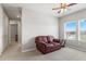 Bright bonus room with natural light, carpet flooring, and a brown leather couch at 5717 Village Center Dr, Lithia, FL 33547