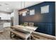 Dining area features modern lighting fixture and views of the kitchen at 5717 Village Center Dr, Lithia, FL 33547