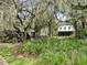 Charming community buildings are nestled among lush trees at 5717 Village Center Dr, Lithia, FL 33547