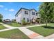 Beautiful two-story home featuring manicured landscaping, a walkway, and a welcoming facade at 5717 Village Center Dr, Lithia, FL 33547