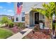 Attractive front porch featuring stone accents, landscaping and an American flag at 5717 Village Center Dr, Lithia, FL 33547