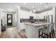 Modern kitchen with white cabinets, stainless steel appliances and granite countertops at 5717 Village Center Dr, Lithia, FL 33547
