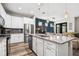 Bright, open kitchen featuring a granite island, stainless appliances, and stylish lighting at 5717 Village Center Dr, Lithia, FL 33547
