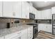 Well-equipped kitchen with stainless steel appliances, granite countertops, and a sleek backsplash at 5717 Village Center Dr, Lithia, FL 33547