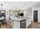 Open floor plan with island, stainless dishwasher, and pendant lights at 5717 Village Center Dr, Lithia, FL 33547