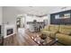 Open concept living room featuring fireplace, kitchen and dining room at 5717 Village Center Dr, Lithia, FL 33547