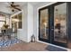Covered patio area with brick flooring, ceiling fan, dining table, and outdoor seating at 5717 Village Center Dr, Lithia, FL 33547