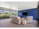 Relaxing screened patio with stylish wicker furniture and entertainment center overlooking a lush backyard at 5717 Village Center Dr, Lithia, FL 33547