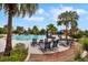 Community pool and lounge area with palm trees offer a relaxing outdoor space at 5717 Village Center Dr, Lithia, FL 33547