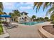 Resort-style swimming pool with a sundeck and lounge chairs, surrounded by tropical landscaping at 5717 Village Center Dr, Lithia, FL 33547