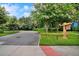 Scenic street view features lush greenery and a 'Lake House' community sign at 5717 Village Center Dr, Lithia, FL 33547