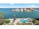 Community pool overlooking stunning bay views, lounge chairs, and tropical landscaping at 6025 Shore S Blvd # 409, Gulfport, FL 33707