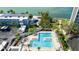 Community pool area with lounge chairs, mature palms, and views of the intercoastal waterway at 6025 Shore S Blvd # 409, Gulfport, FL 33707