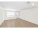 Bright, empty room with light wood flooring and ocean view at 6025 Shore S Blvd # 409, Gulfport, FL 33707