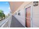Condo exterior featuring a walkway, railing, and entrance door at 6025 Shore S Blvd # 409, Gulfport, FL 33707