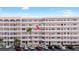 Multi-story condo building with several units, palm trees, and parking at 6025 Shore S Blvd # 409, Gulfport, FL 33707