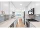 Modern kitchen with white cabinets, stainless appliances, and quartz countertops at 6025 Shore S Blvd # 409, Gulfport, FL 33707