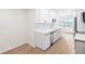 Updated kitchen with white cabinets, modern appliances, and a window view at 6025 Shore S Blvd # 409, Gulfport, FL 33707