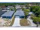 An aerial view showcasing a new home with a concrete driveway at 6097 Vermont Ave, New Port Richey, FL 34653