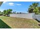 Large backyard features a new white fence at 6097 Vermont Ave, New Port Richey, FL 34653