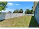 Large backyard features a new white fence at 6097 Vermont Ave, New Port Richey, FL 34653