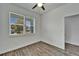Bedroom featuring one window with blinds, wood-look flooring, and white walls at 6097 Vermont Ave, New Port Richey, FL 34653