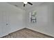 Bedroom featuring a ceiling fan, one window with blinds, and wood-look flooring at 6097 Vermont Ave, New Port Richey, FL 34653